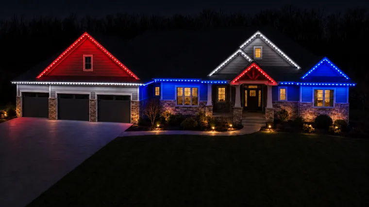 A home at night with permanent roofline lighting set to fourth of july
